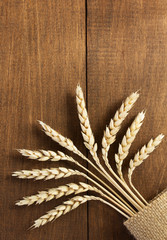 ears of wheat on wood
