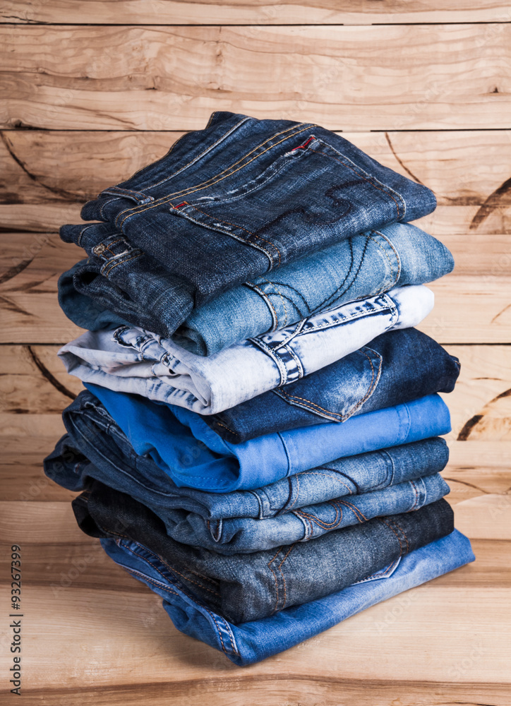 Canvas Prints fashionable clothes. pile of jeans on a wooden background