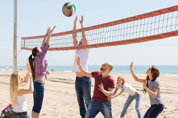 Friends playing volleyball at beach