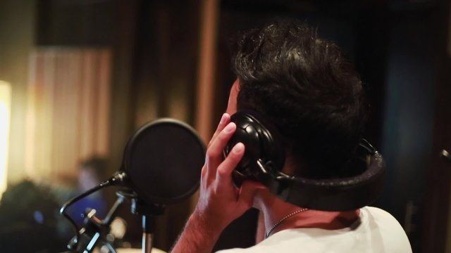 Singer recording vocals at recording studio