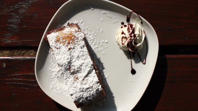 Hand serving a cake strudel