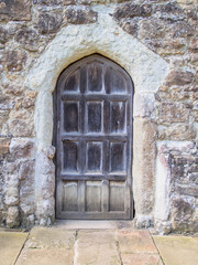 Old Wooden Door situated in a stone wall