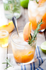 Fototapeta premium Peach and rosemary fizz cocktail