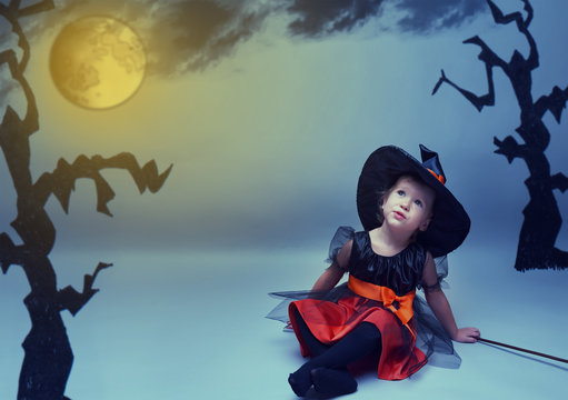 Halloween. little witch dreams fly to the moon in night sky