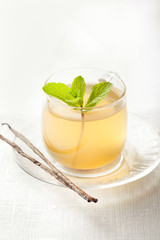 Herbal mint and vanilla tea in glass cup