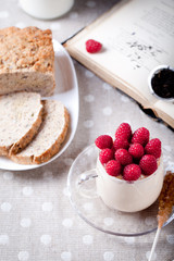 Yogurt with fresh raspberries, bread, tea