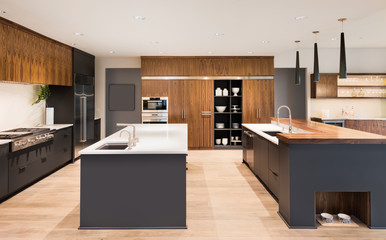 Kitchen Interior in New Luxury Home with Two Islands, Sinks, and Beautiful Hardwood Cabinetry and...