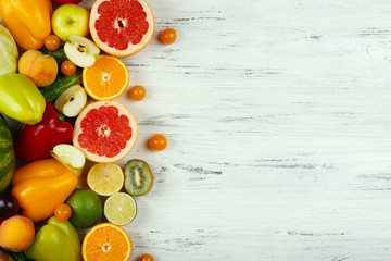 Heap of fresh fruits and vegetables on wooden background