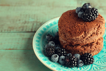 Cake with berries on wooden table