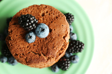 Cake with berries on wooden table