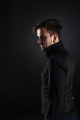 Fototapeta premium handsome brutal guy with beard on dark background