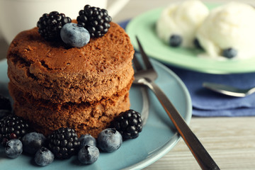 Cakes with berries and tea on the table