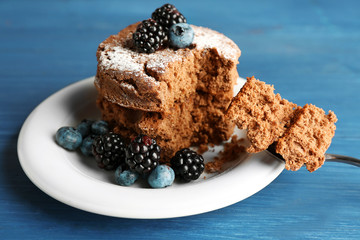 Cake with berries on wooden table
