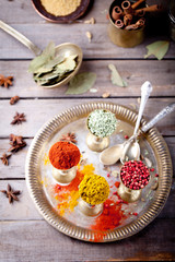 Various Indian spices in vintage metal cups
