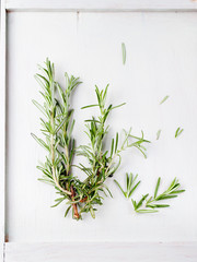 Fresh rosemary bound, sprigs in a glass