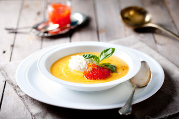 Pumpkin soup with cream and red salmon caviar