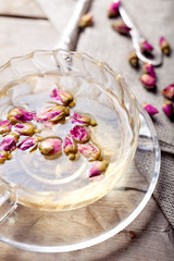 Rose buds herbal tea in a glass cup