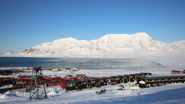 Small town Longyearbyen on the shores of the Arctic Ocean among snow-capped mountains of the Norwegian archipelago of Svalbard.