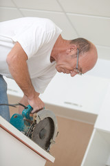 Experienced carpenter using a circular saw