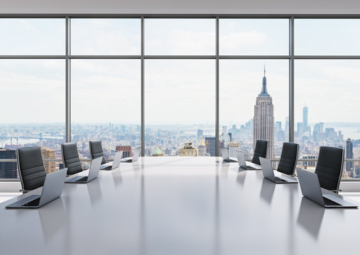 A conference room equipped by modern laptops in a modern panoramic office in New York. Black leather chairs and a white table. 3D rendering.