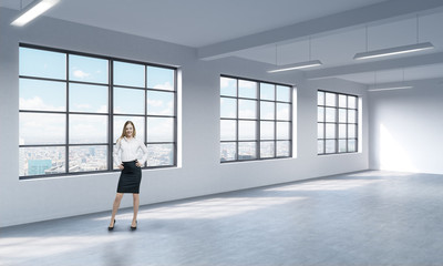 Fototapeta na wymiar A full length woman in formal clothes who is looking out the window, New York panoramic view. A modern loft style open space.