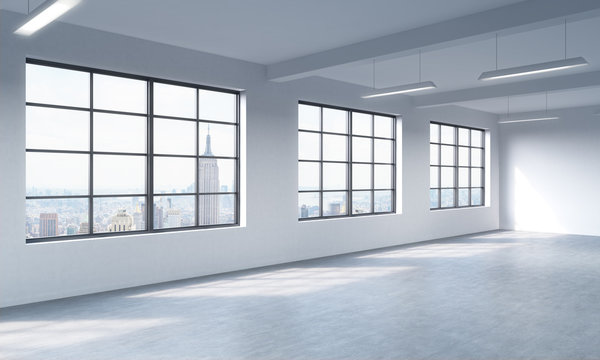 Modern bright clean interior of a loft style open space. Huge windows and white walls. New York panoramic city view. 3D rendering.