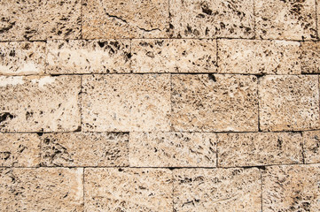 Sediment limestone stone wall detail closeup as background