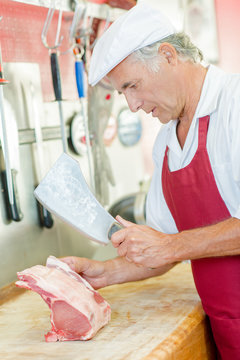 Butcher chopping some pork