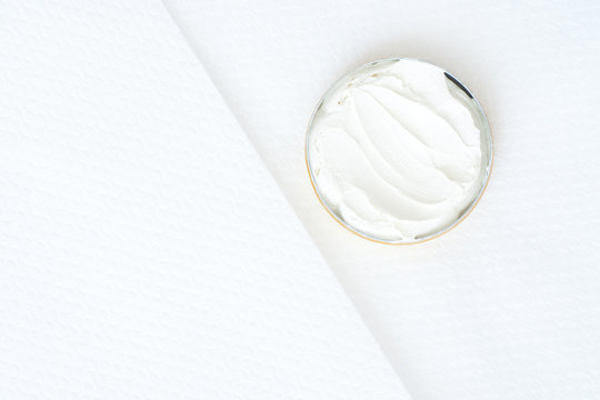 white cream  in a bowl on white textured background - studio sho