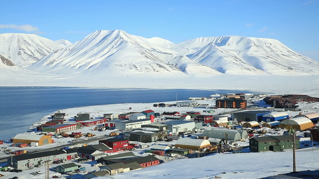 Small town Longyearbyen on the shores of the Arctic ocean among snow-capped mountains of the Norwegian archipelago of Svalbard.
