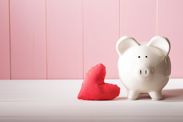 Piggy bank with red heart pillow