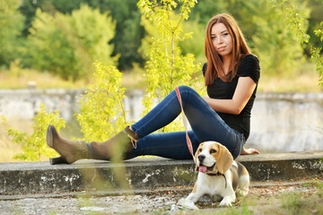 beautiful woman and his dog posing outside