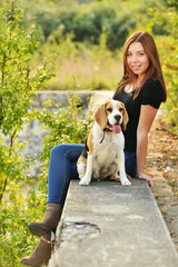 beautiful woman and his dog posing outside