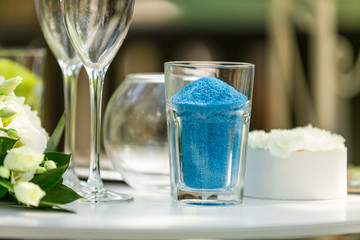 Closeup of decorative blue sand in vase for wedding ceremony