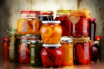 Jars with pickled vegetables and fruity compotes