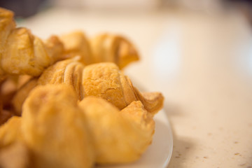 Delicious croissants on plate on table close-up