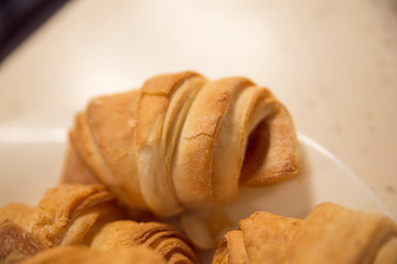 Delicious croissants on plate on table close-up