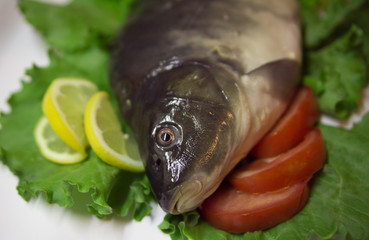 Fresh fish  with a lemon and an tomato