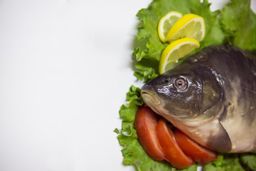 Fresh fish with a lemon and an tomato
