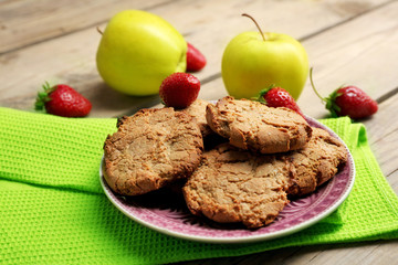 Homemade cookies with strawberries and apples on table close up