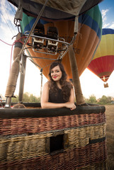Portrait of beautiful woman posing at hot air balloon basket