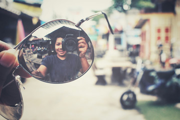 Sun glasses with reflection of woman take a photo