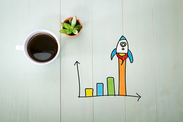 Rocket graph concept with a cup of coffee