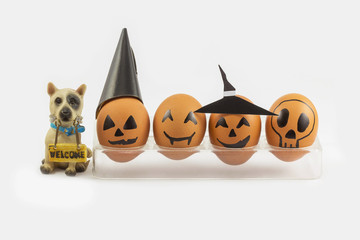Four halloween egg in egg cup and wellcome dog