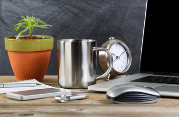 Old wooden working desktop with technology and coffee