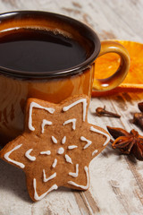 Fresh gingerbread, cup of coffee and spices on old wooden background, christmas time