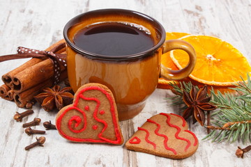 Fresh gingerbread, cup of coffee and spices on old wooden background, christmas time