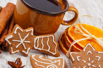 Fresh gingerbread, cup of coffee and spices on old wooden background, christmas time
