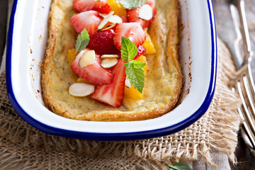 Baked pancake with oranges and strawberries