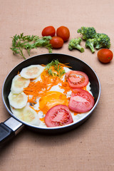 Eggs poached with vegetables on cloth background